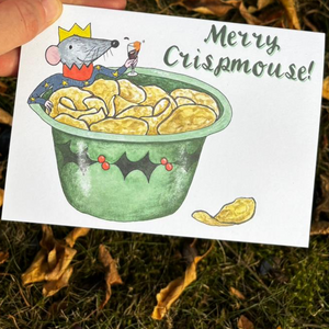 Merry Crispmouse! Christmas card by Alice Savery of Alice Draws the Line, illustrated mouse in bowl of crisps with a glass of mulled wine. Copyright Alice Savery 2025