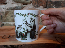 Load image into Gallery viewer, Christmas Badgers China Mug, Badgers with holly, ivy and mistletoe illustrations by Alice Draws The Line