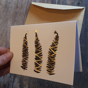 Three fern trees with gold foil detail Christmas Card by Alice Draws the Line, gold baubles and gold tinsel