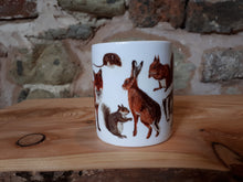 Load image into Gallery viewer, Woodland animals mug featuring a fox, badger, hedgehog, hare and red squirrel